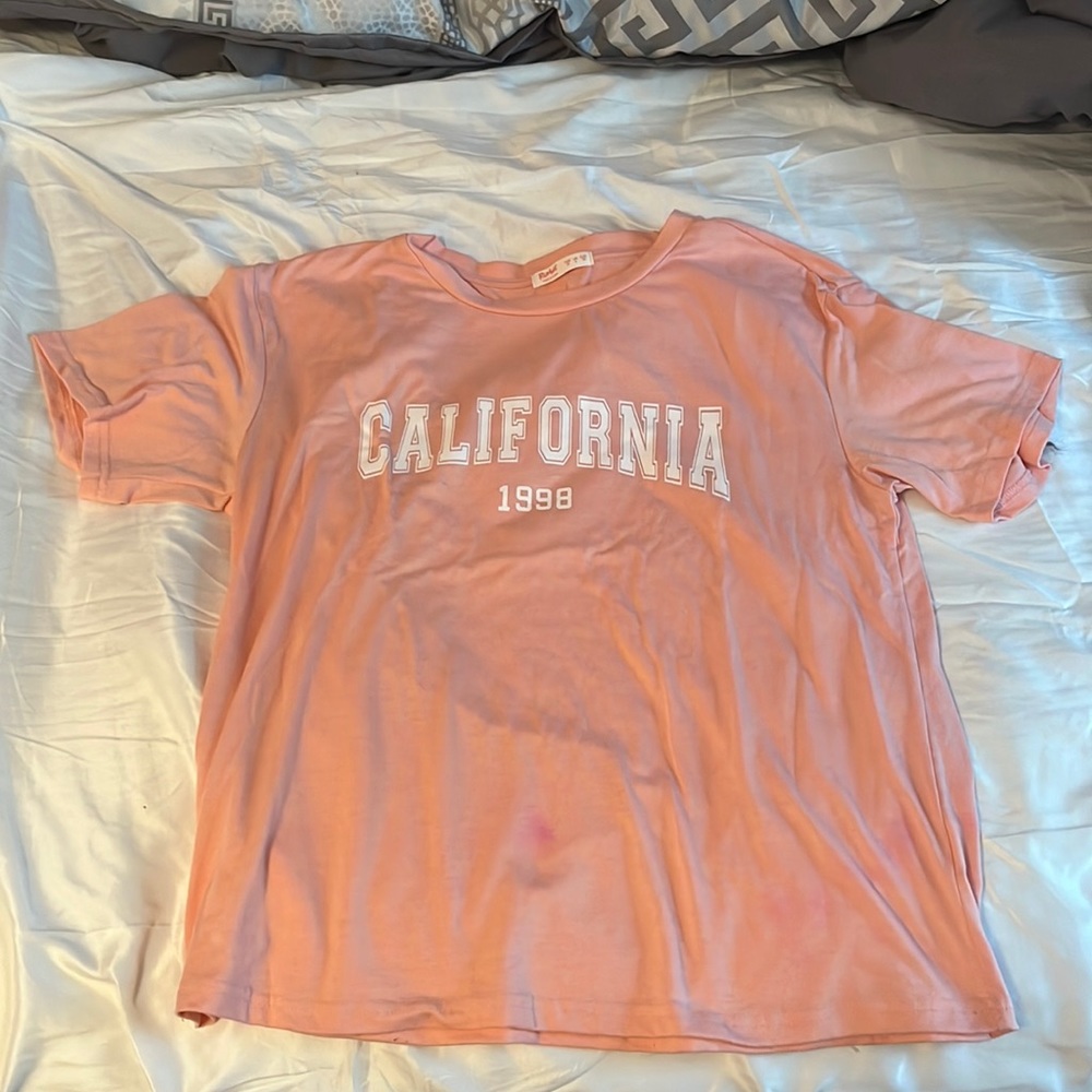 California 1998 T-Shirt. Small light pink stain towards very bottom of shirt.